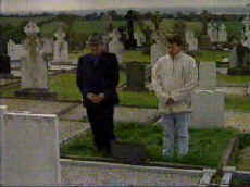 Kevin Ludlow and Jimmy Sharkey at the grave of Seamus Ludlow, in Ravensdale's Catholic Calvary Cemetery.